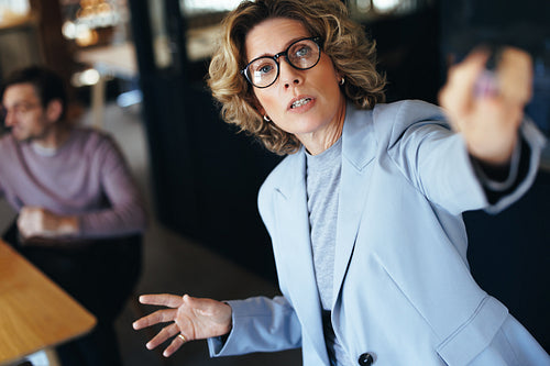 Female professional giving a presentation in an office