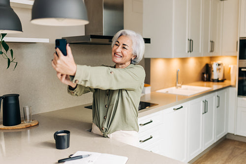 Retired senior woman taking a video call on her smartphone
