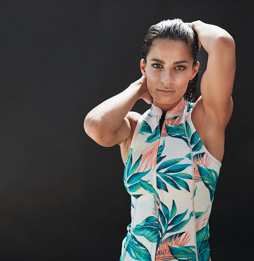 Beautiful young female model posing over black background