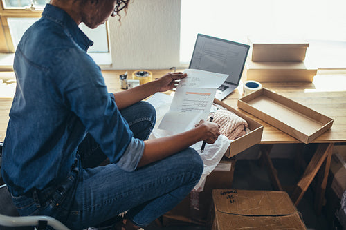 Woman preparing shipment for delivery