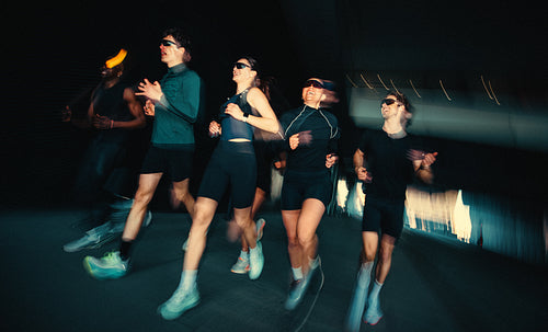 Motion blur follows running as the group trains together outdoors