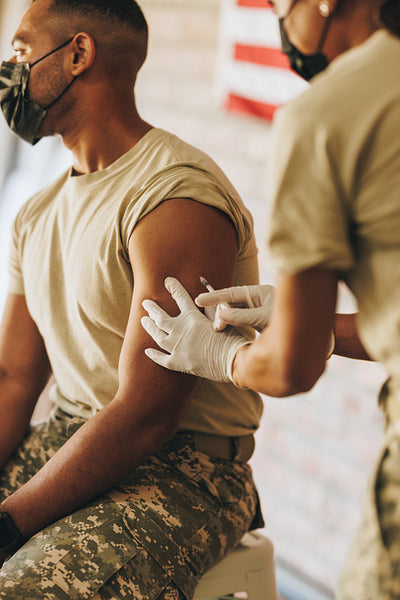 Young serviceman getting vaccinated against coronavirus disease