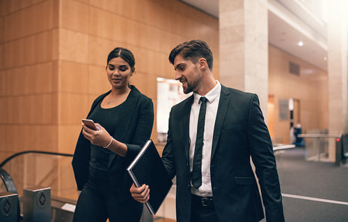 Two young people walking together in airport terminal
