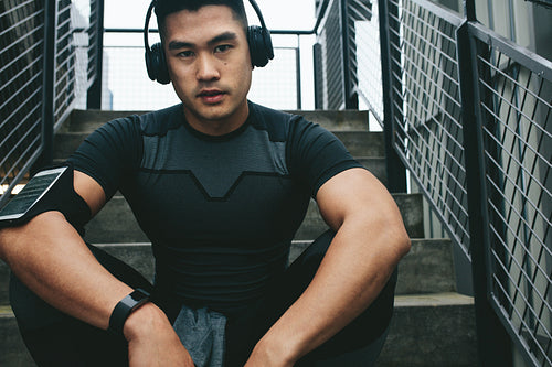 Asian man relaxing after workout