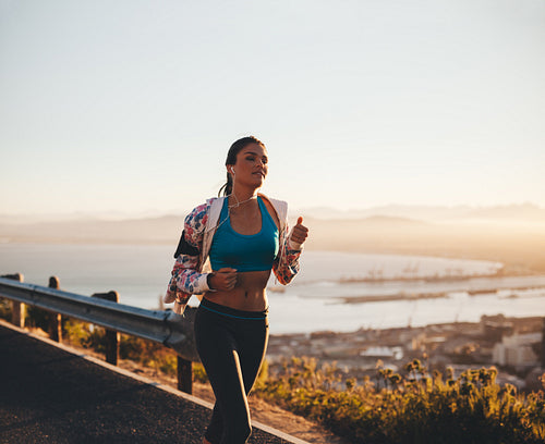 Young fitness woman running outdoors