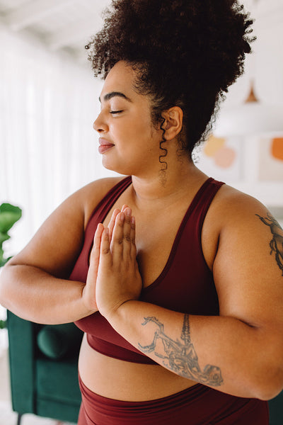 Healthy fitness woman doing yoga at home