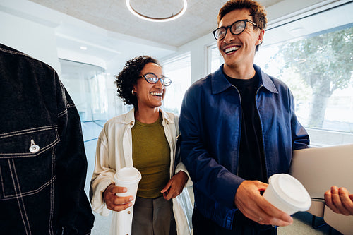 Friends in tech enjoy coffee and laptop moment