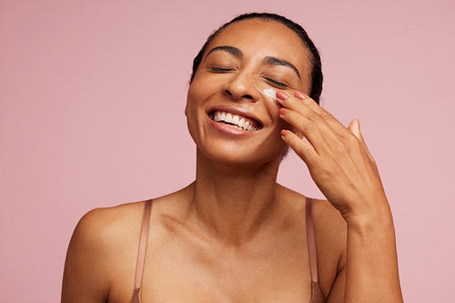 Female applying anti-aging cream