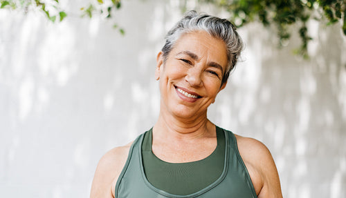 Retired and active: Mature woman smiling at the camera outdoors