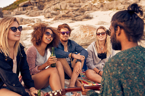 Diverse group of friends hanging out at beach