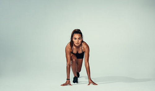 Confident female athlete ready for running