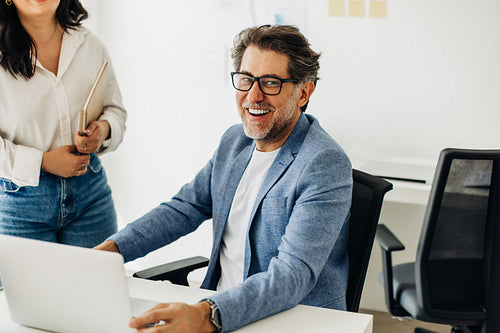 Experienced designer working with a laptop in an office