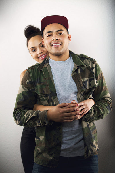Young couple in love together on grey background