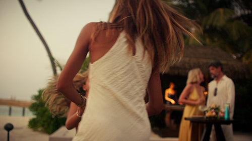Happy mother and daughter dance playfully enjoying a tropical resort vacation together