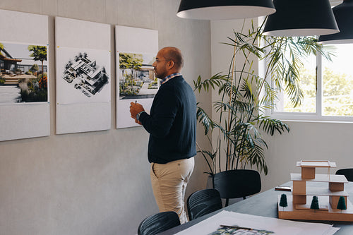 Architect reviews building plans during project planning and overview session