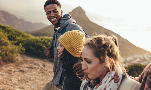 African man with friends on hiking trip
