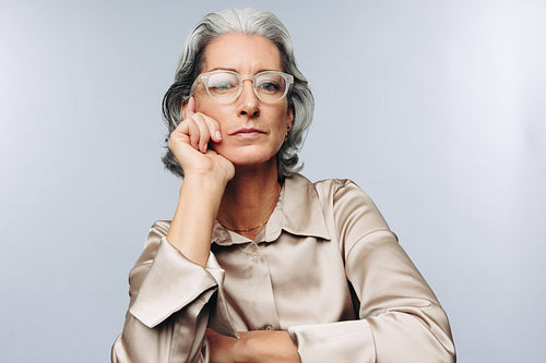 Woman resting chin on hand in studio