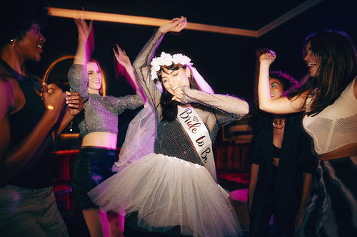 Bride-to-be celebrating with friends during her lively bachelorette party night