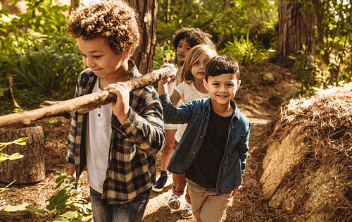 Kids making camp in forest