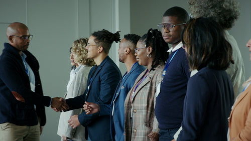 Connecting diverse professionals with warm handshakes at a corporate event