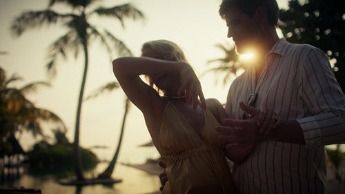 Romantic sunset dance of a happy couple on a beautiful tropical beach