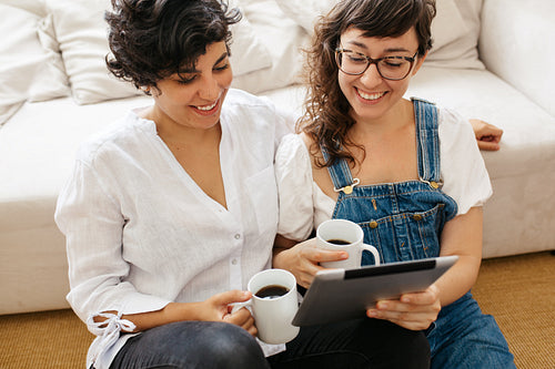 Happy lesbian couple with digital tablet