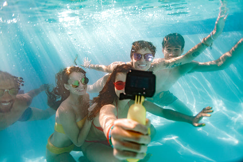 Group of young people taking selfie underwater