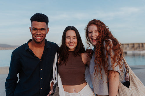 Portrait of three diverse friends smiling at the camera