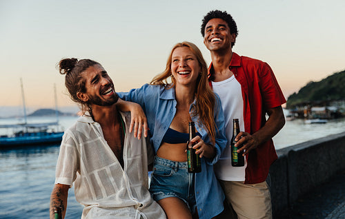 Friends enjoying a sunset at Urca’s Wall with drinks and laughter