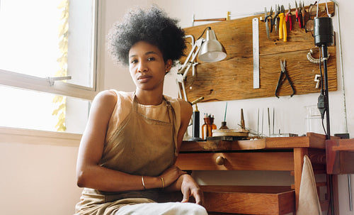 Female jewelry designer looking at camera