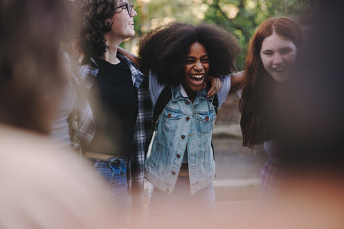 Cheerful teenage activists standing together in a circle