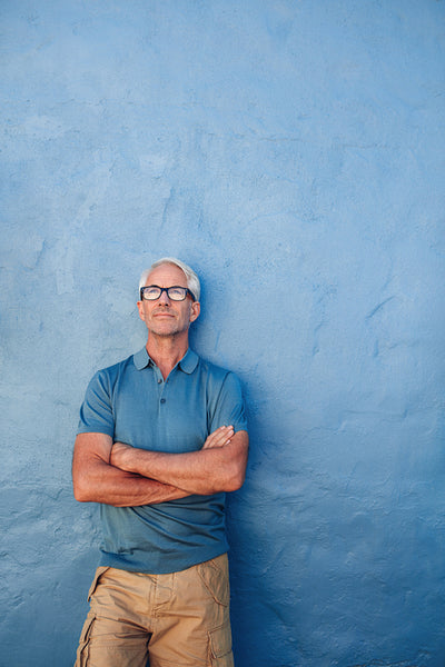 Confident mature man looking up at copy space