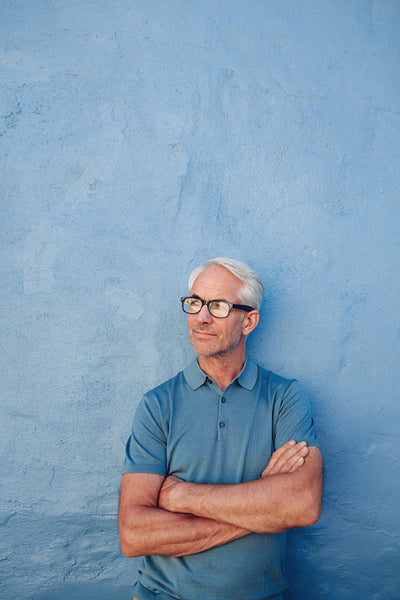 Mature man with glasses looking away at copy space