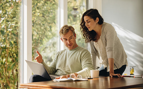 Couple with laptop at home