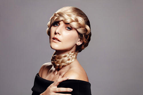 Sensual woman with creative braid hairdo