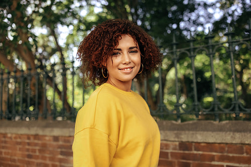 Portrait of a young teenage gurl smiling cheerfully outdoors
