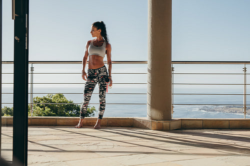 Fit young woman standing in the balcony