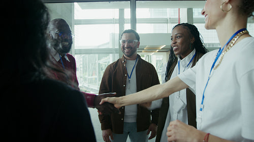 Diverse professionals happily shaking hands