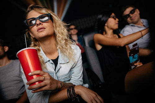 Woman watching 3d movie in theater