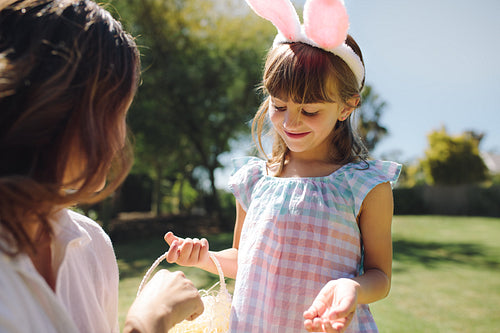 Kid playing with her mother in garden