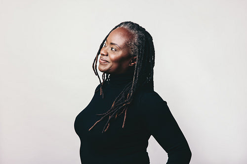 Pensive mature woman looking away with a smile