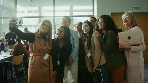 Group takes happy selfie at conference