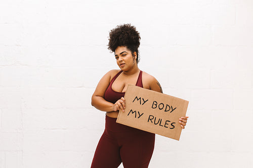 Woman with signboard of "My body my rules"