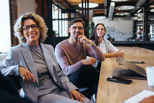 Business colleagues listening to a discussion in a meeting