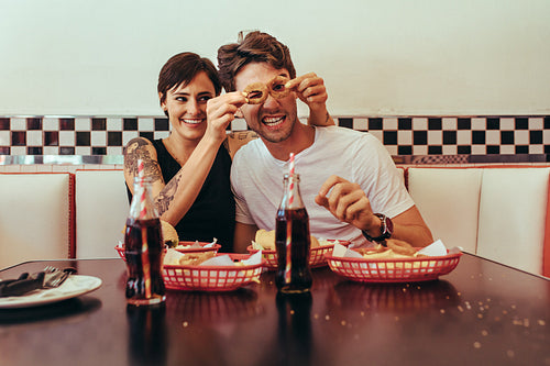 Happy couple at a restaurant table having fun
