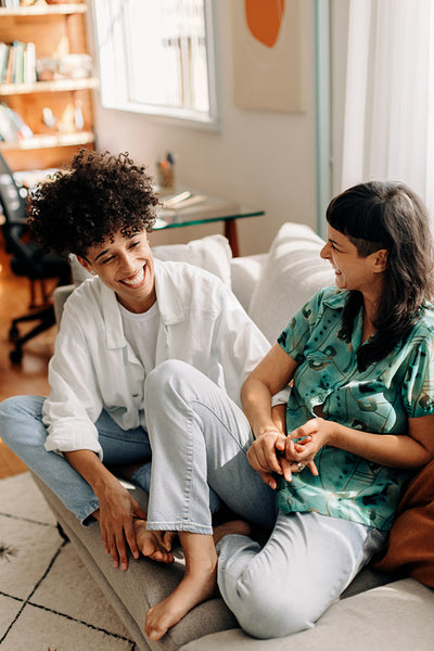 Cheerful lesbian couple laughing together