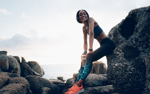 Smiling woman resting outdoors after workout