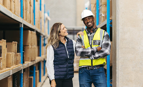 Warehouse employees smiling happily at work