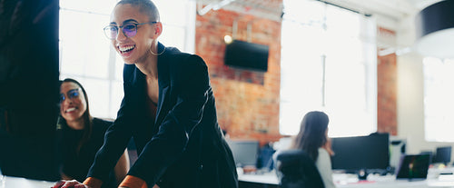 Happy young businesswoman using a desktop while working with her