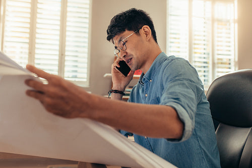 Architect using phone at his workplace